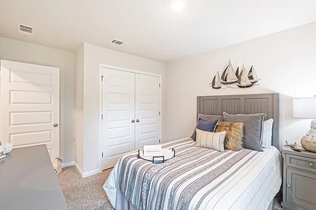 a bedroom with a bed and cabinets