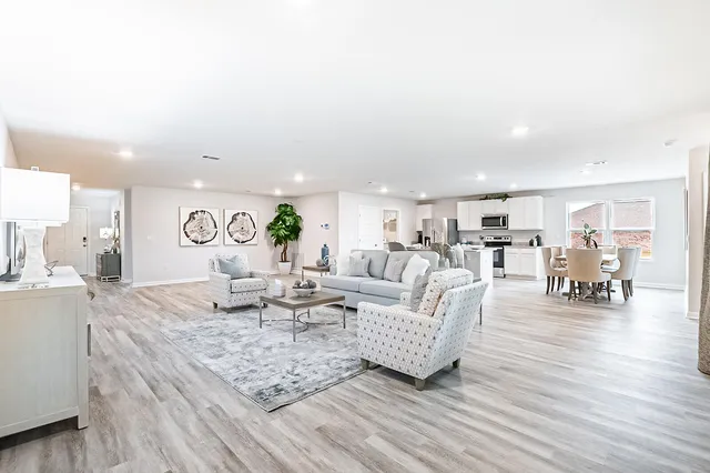 a living room with furniture and wooden floor