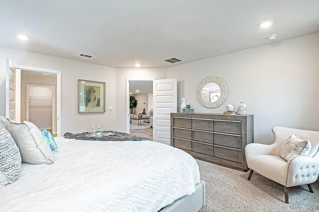 a bedroom with a bed and a couch