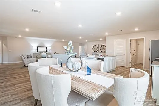 a very nice looking dining room with kitchen island a table and chairs