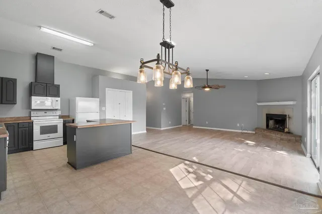 a view of a kitchen with a stove cabinets and a floor to ceiling window