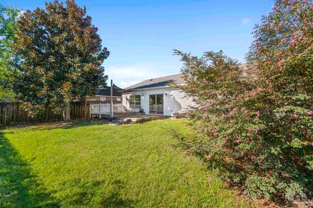 a backyard of a house with table and chairs