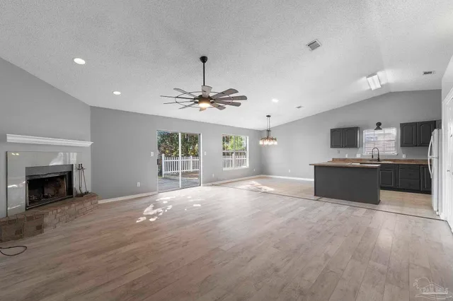 a view of a kitchen with a sink and a fireplace
