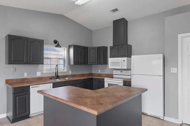 a kitchen with a sink a stove and refrigerator