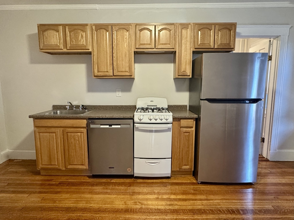 1615 Commonwealth Avenue, Unit 6 Boston, MA 02135 - Photo 1 of 11 a white refrigerator freezer sitting in a kitchen