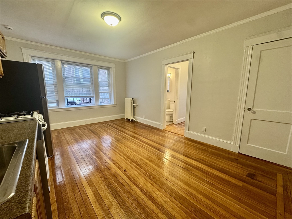 1615 Commonwealth Avenue, Unit 6 Boston, MA 02135 - Photo 3 of 11 a view of a room with wooden floor and windows
