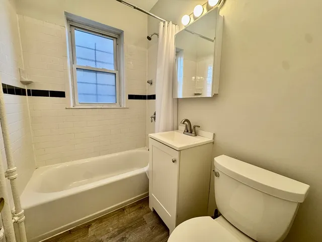 a bathroom with a toilet a sink and bathtub