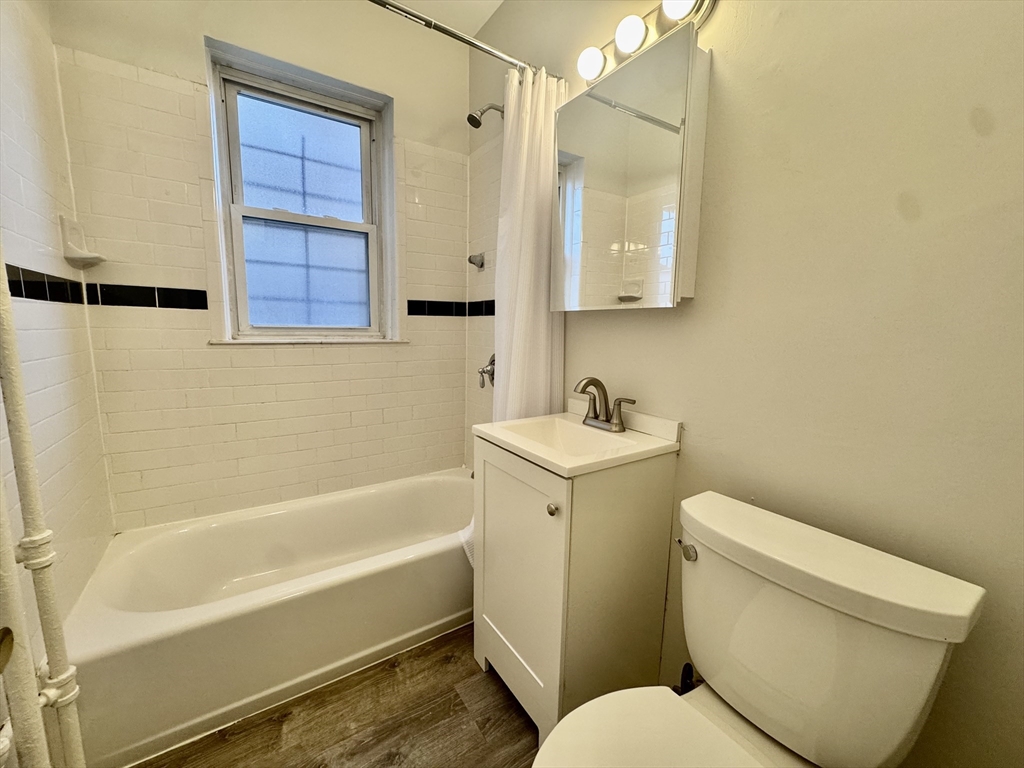 1615 Commonwealth Avenue, Unit 6 Boston, MA 02135 - Photo 6 of 11 a bathroom with a toilet a sink and bathtub