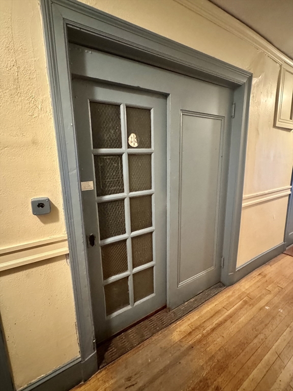 1615 Commonwealth Avenue, Unit 6 Boston, MA 02135 - Photo 9 of 11 a view of an empty room with wooden floor and a window