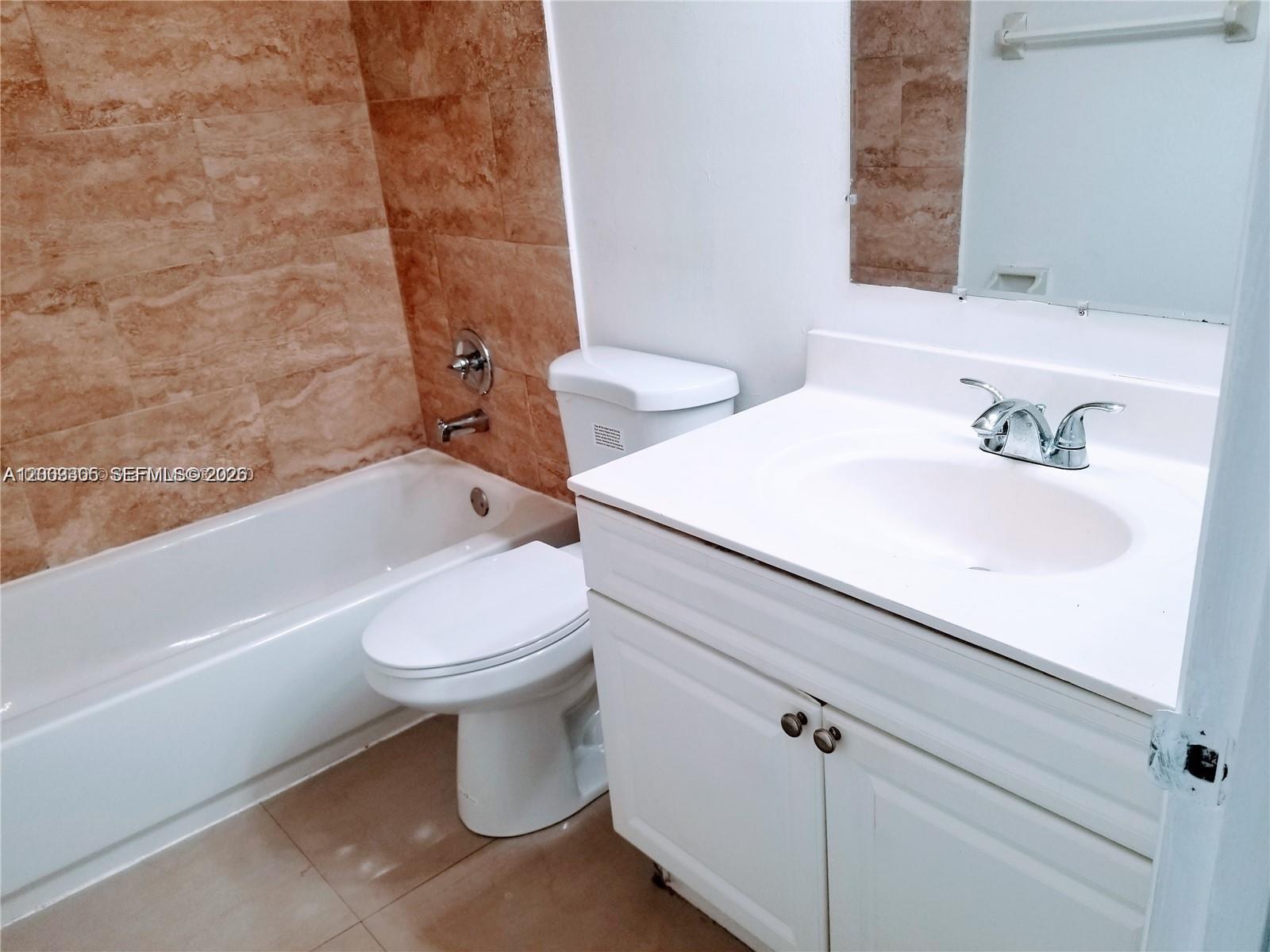 6943 Southwest 40th Street, Unit 11R Miramar, FL 33023 - Photo 3 of 11 a bathroom with a sink a toilet and a bathtub