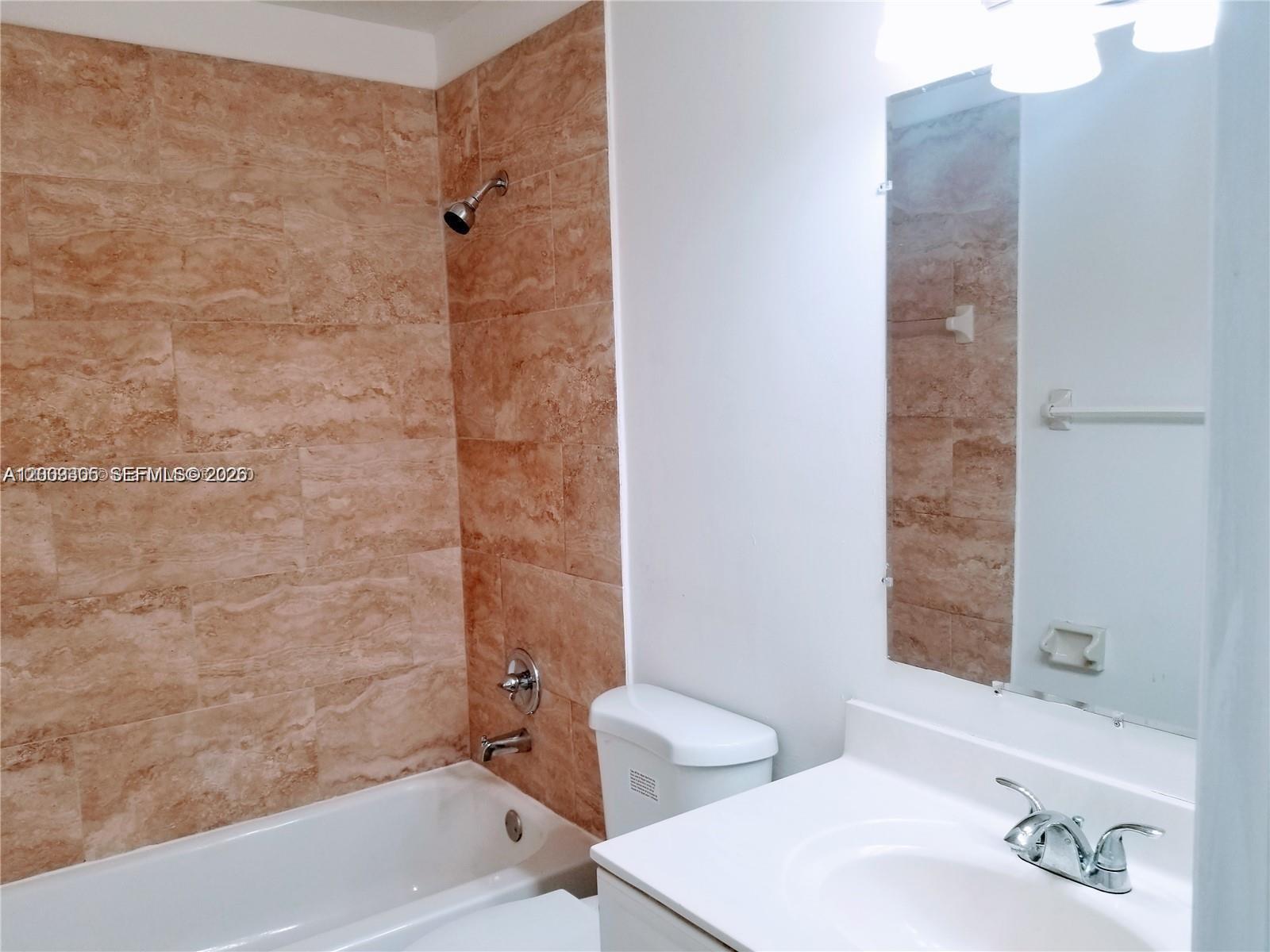 6943 Southwest 40th Street, Unit 11R Miramar, FL 33023 - Photo 4 of 11 a bathroom with a bathtub and a sink