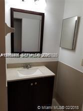6943 Southwest 40th Street, Unit 11R Miramar, FL 33023 - Photo 10 of 11 a bathroom with a sink and a mirror