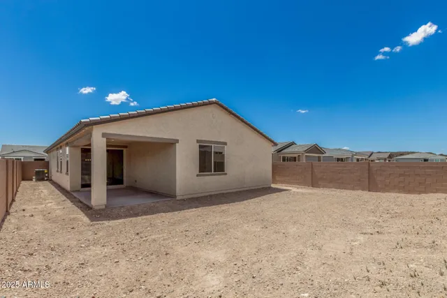 a view of a house with a backyard