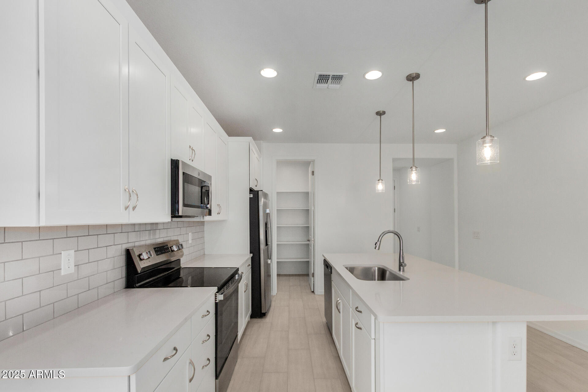 18474 East Dario Road Gold Canyon, AZ 85118 - Photo 4 of 36 a kitchen with a sink a stove a refrigerator and cabinets