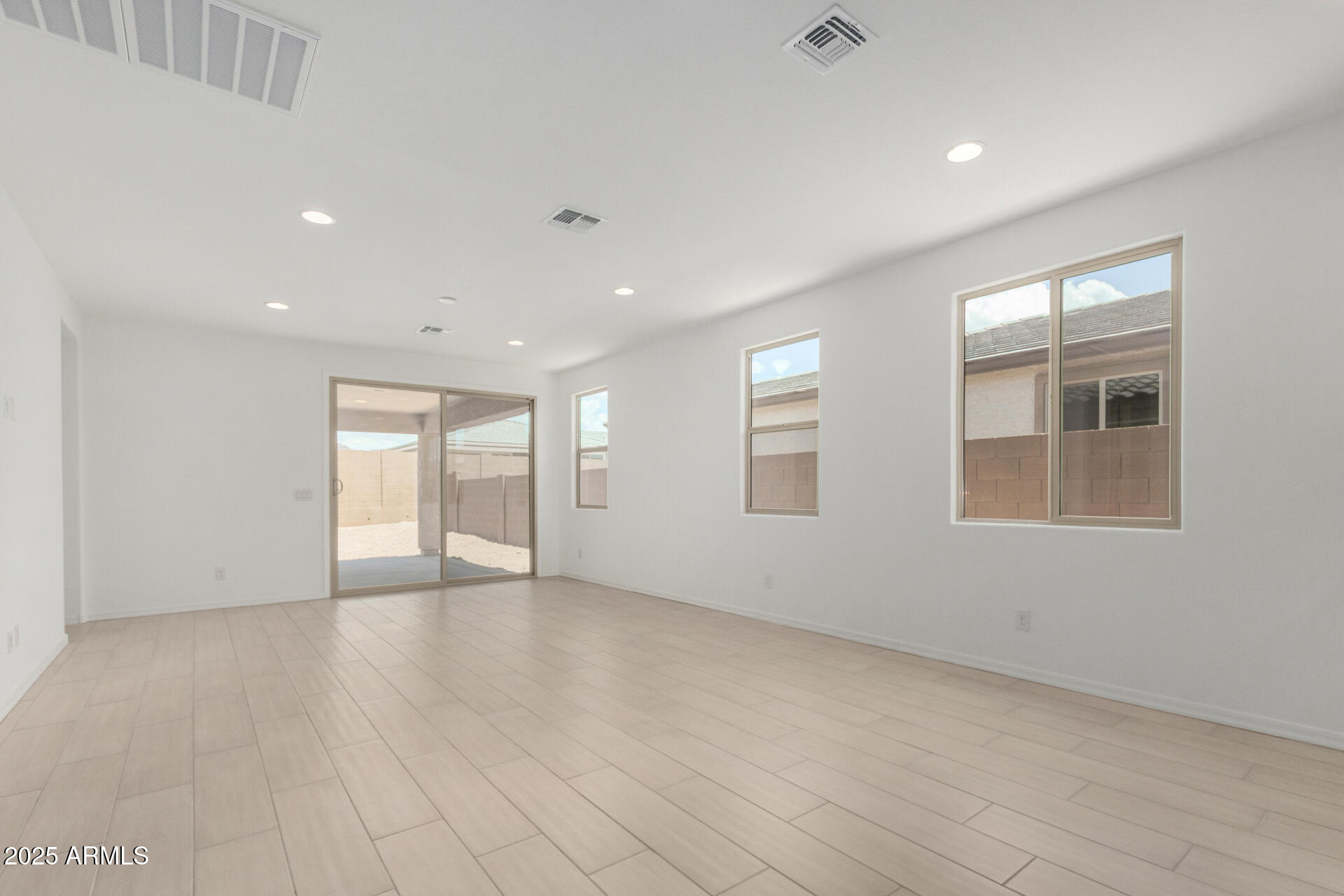 18474 East Dario Road Gold Canyon, AZ 85118 - Photo 6 of 36 a view of an empty room with wooden floor and a window