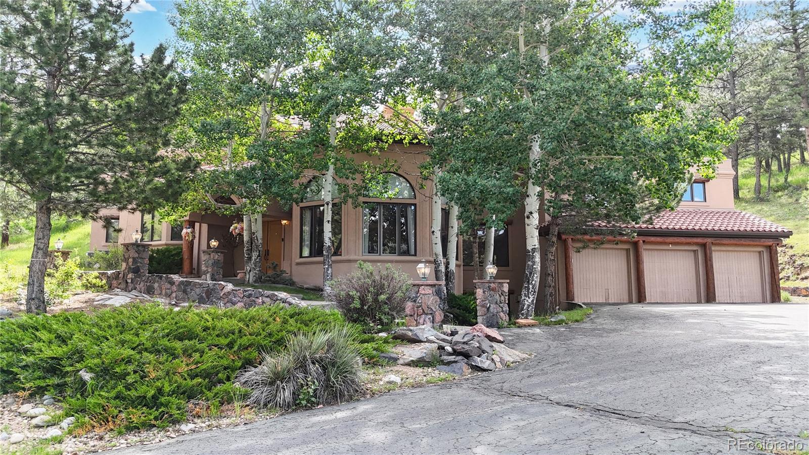 974 Spring Ranch Drive Golden, CO 80401 - Photo 2 of 50 a front view of a house with garden