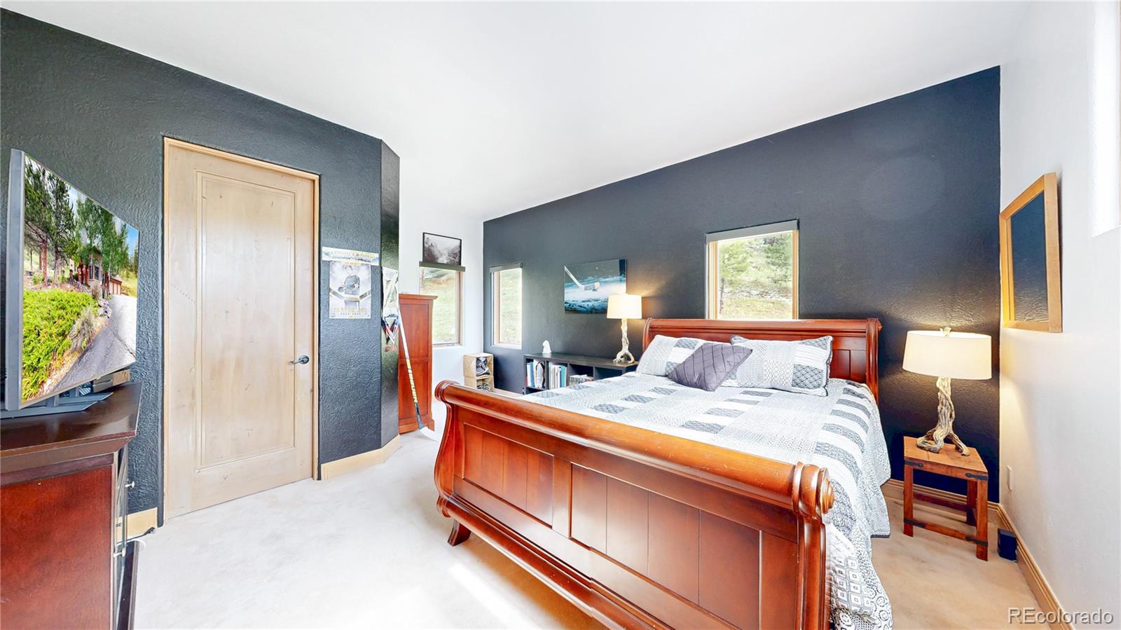 974 Spring Ranch Drive Golden, CO 80401 - Photo 22 of 50 a bed room with a bed and a mirror