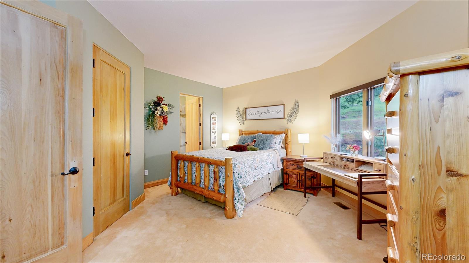974 Spring Ranch Drive Golden, CO 80401 - Photo 24 of 50 a bedroom with a bed and a window