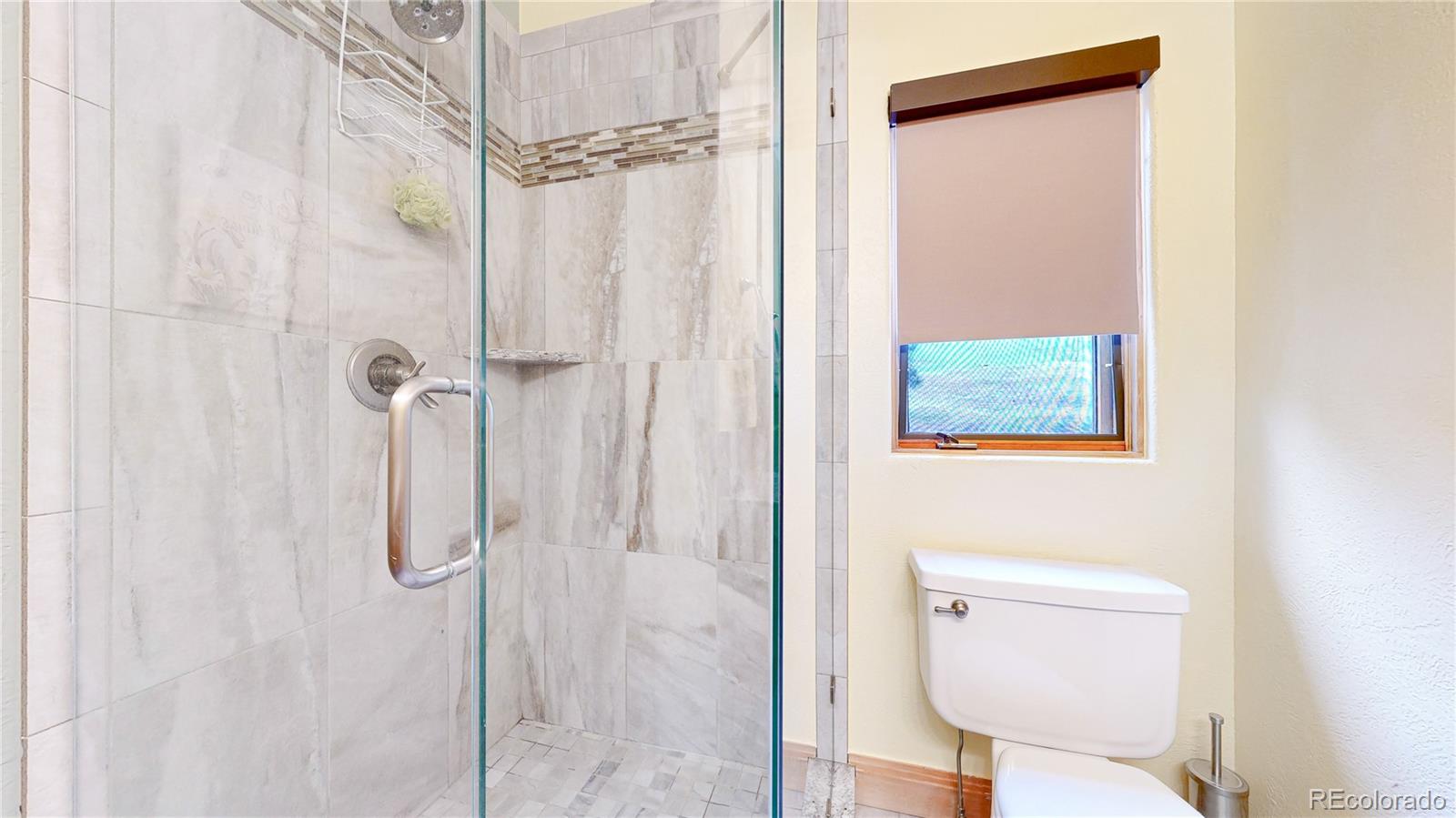 974 Spring Ranch Drive Golden, CO 80401 - Photo 27 of 50 a bathroom with a toilet and a shower