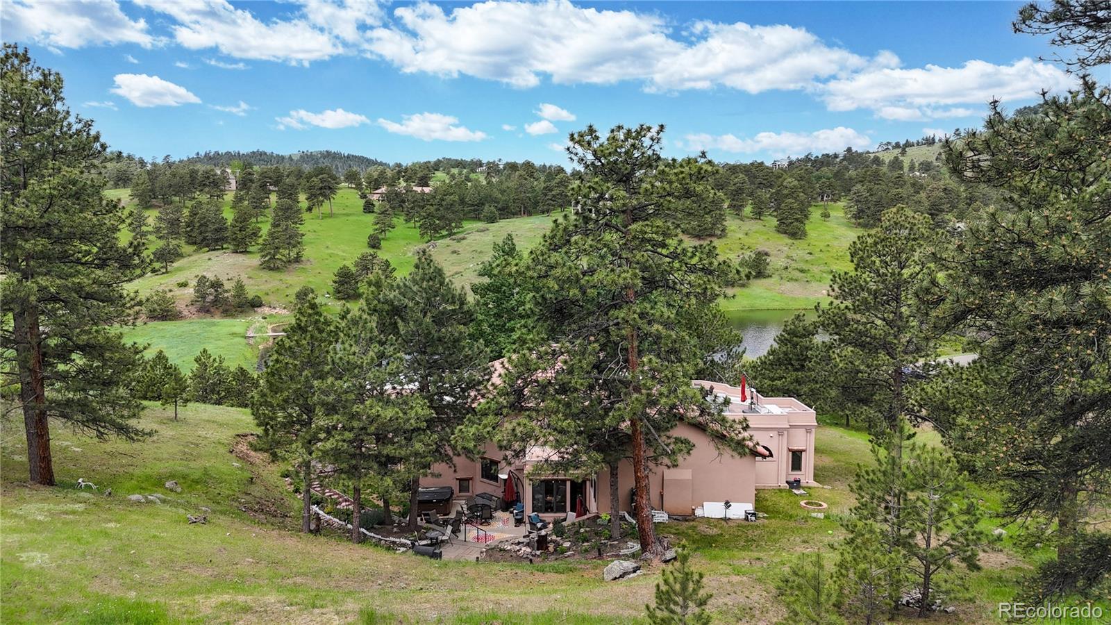 974 Spring Ranch Drive Golden, CO 80401 - Photo 47 of 50 an aerial view of house with yard swimming pool and mountain view