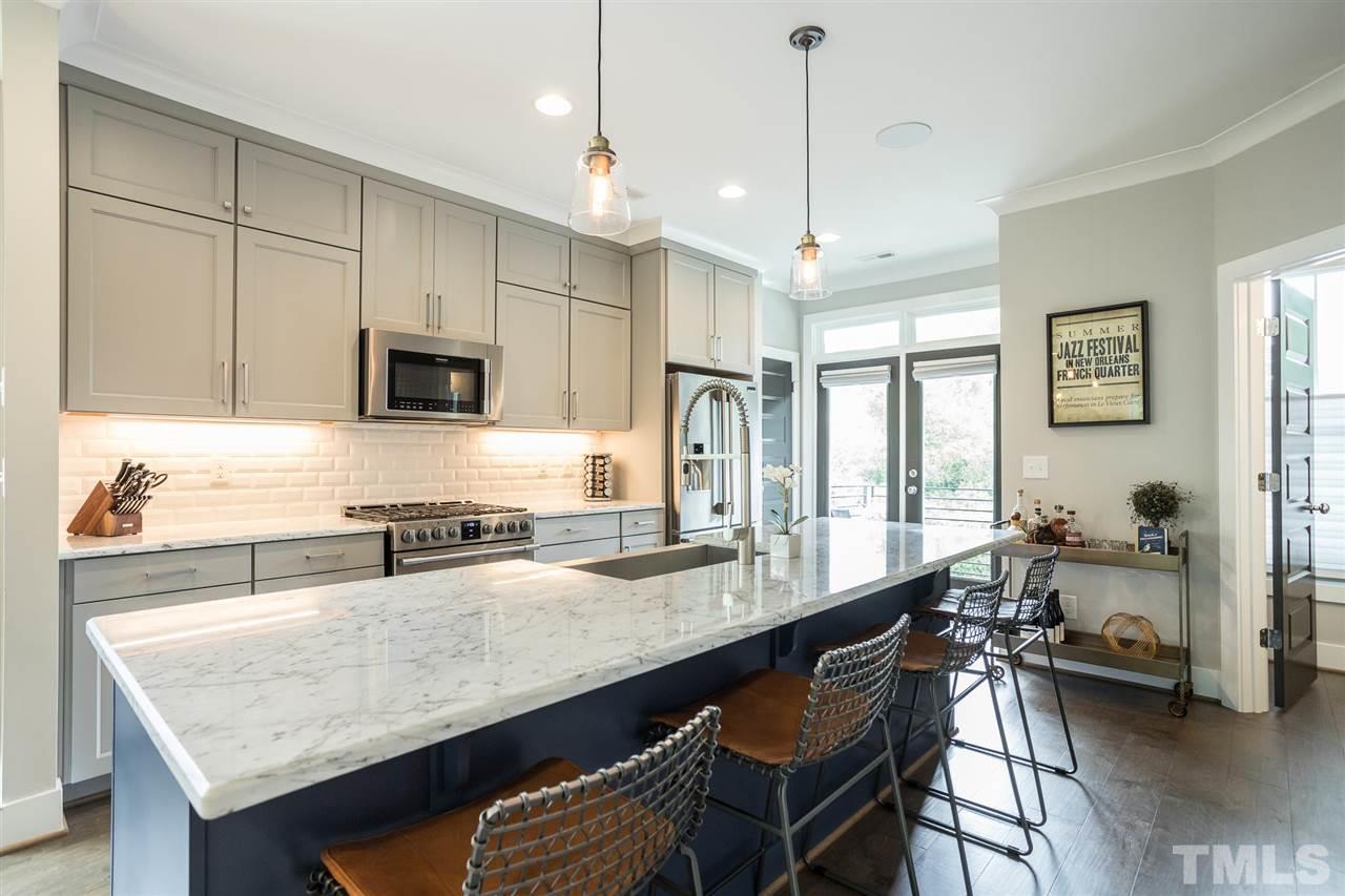 660 Watauga Street Raleigh, NC 27604 - Photo 14 of 29 a kitchen with granite countertop a stove a sink a counter space and dining table