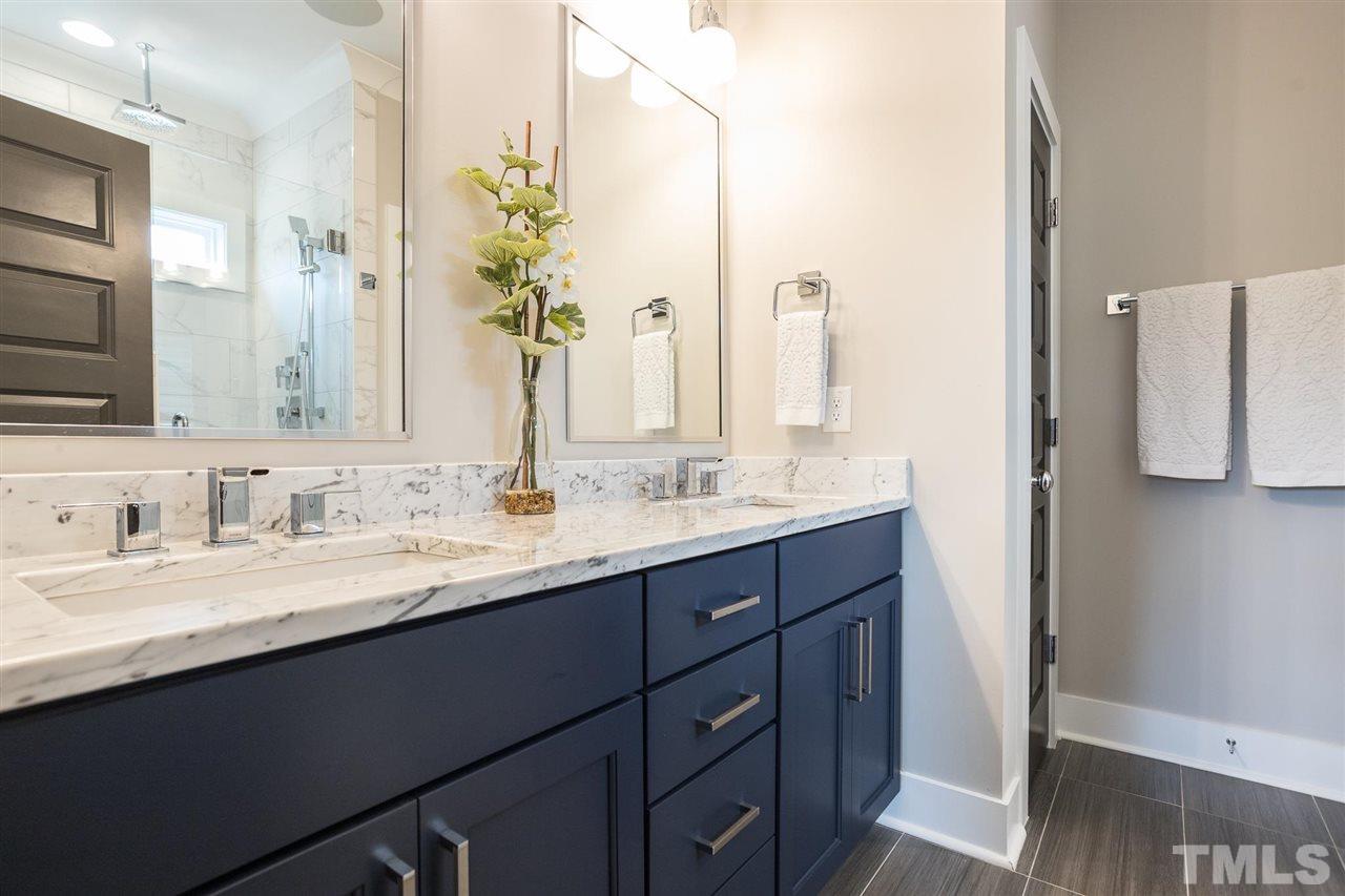 660 Watauga Street Raleigh, NC 27604 - Photo 22 of 29 a bathroom with a double vanity sink and a mirror