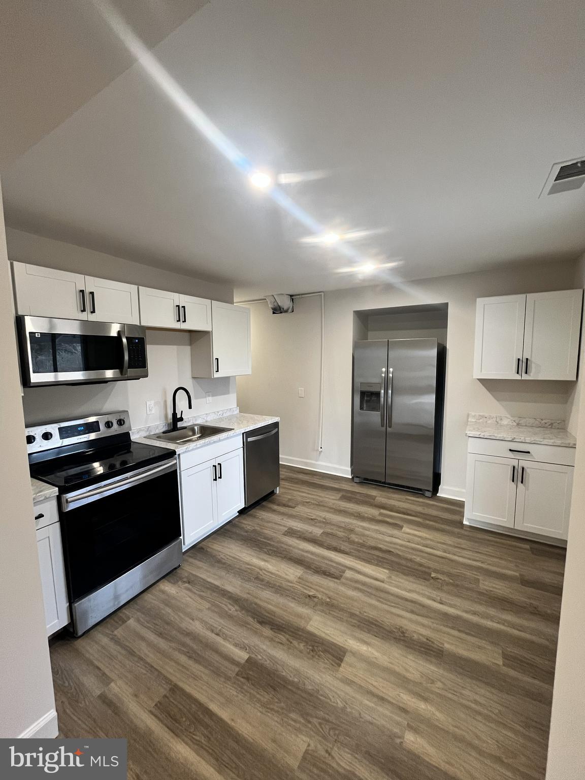 301 Bryan Point Road, Unit B Accokeek, MD 20607 - Photo 4 of 12 a large kitchen with stainless steel appliances granite countertop a stove and a refrigerator