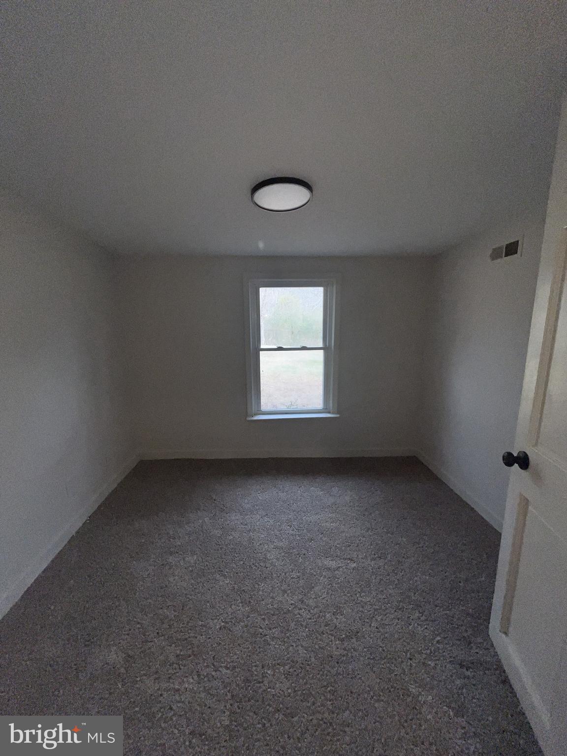 301 Bryan Point Road, Unit B Accokeek, MD 20607 - Photo 10 of 12 an empty room with a window
