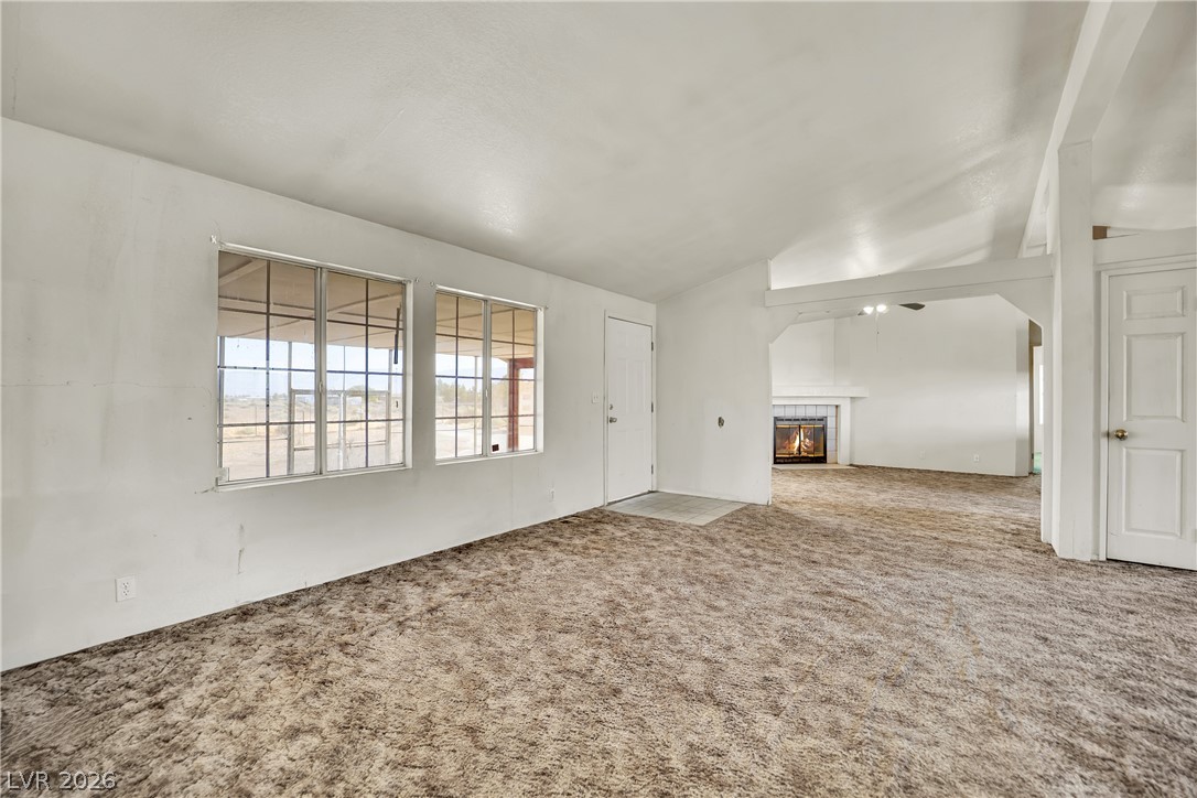4361 Maple Road Pahrump, NV 89048 - Photo 7 of 46 A spacious living room offers an inviting fireplace, perfect for cozy evenings.
