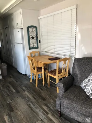 a dining room with furniture and window