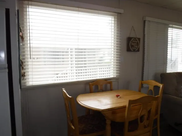 a view of a dining room with furniture and windows
