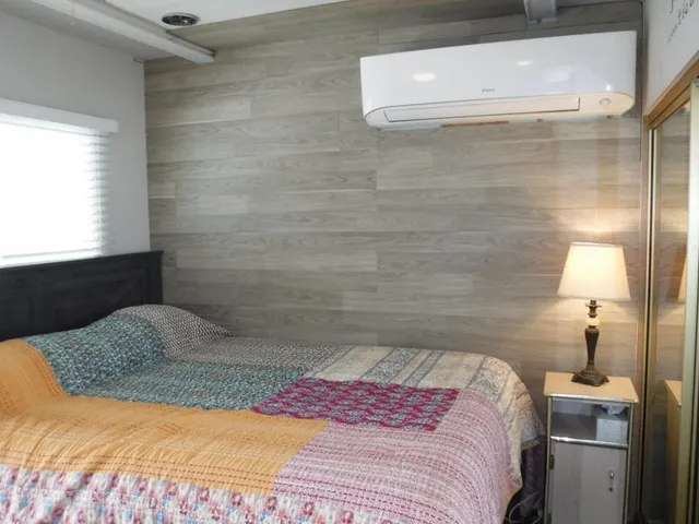 a bedroom with a bed and a night stand