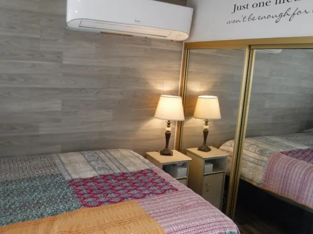 a bedroom with a bed and a lamp