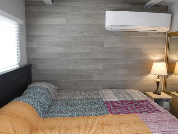 a bedroom with a bed and a lamp