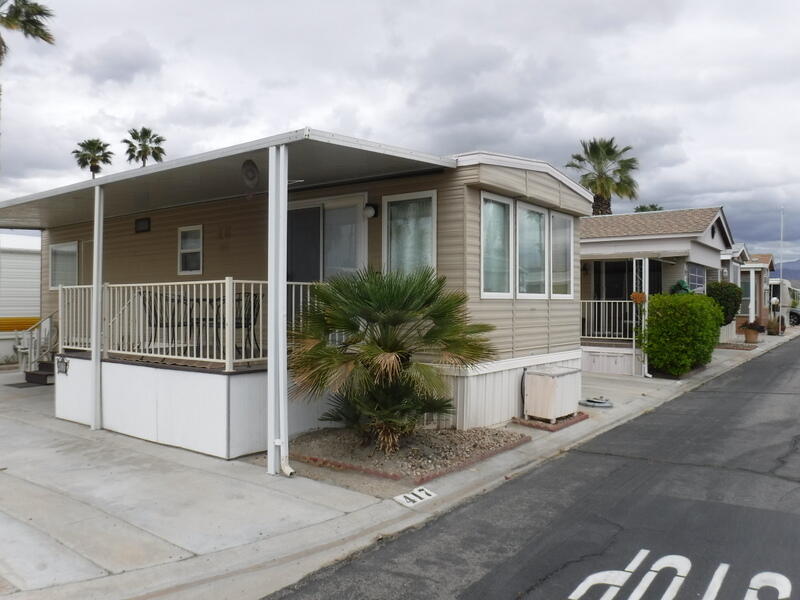 Undisclosed Address Indio, CA 92203 - Photo 3 of 33 a front view of a house with garden