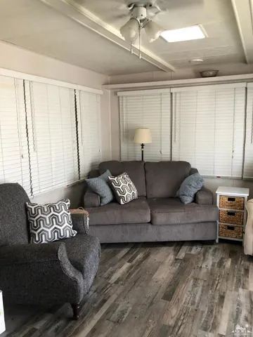 a living room with furniture and a large window