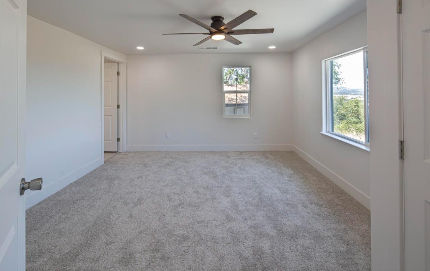14594 Perricone Road Jamestown, CA 95327 - Photo 22 of 48 an empty room with windows and fan