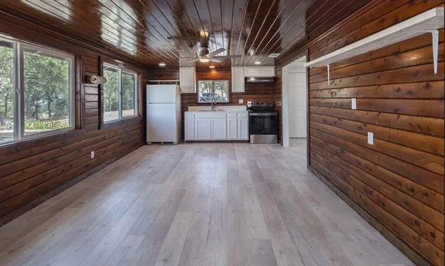 a view of kitchen and refrigerator