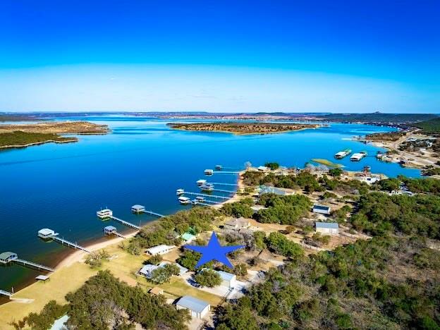 1935 Deer Trail Road Graford, TX 76449 - Photo 1 of 36 PRIME PK PENINSULA LOCATION, 3bd/2ba Lakehouse with Dock on 0.89AC Stunning Grassy, Mature Oak Tree Lot, Close to all the Amenities at PK & Hiking Trails as well.