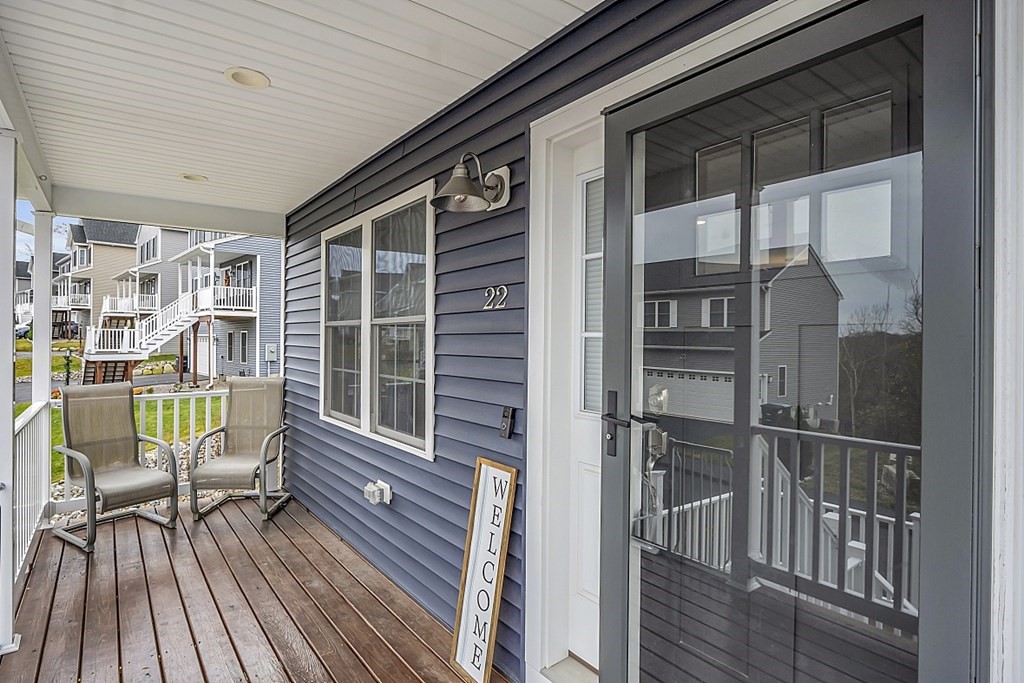 a view of balcony with two chairs and wooden floor