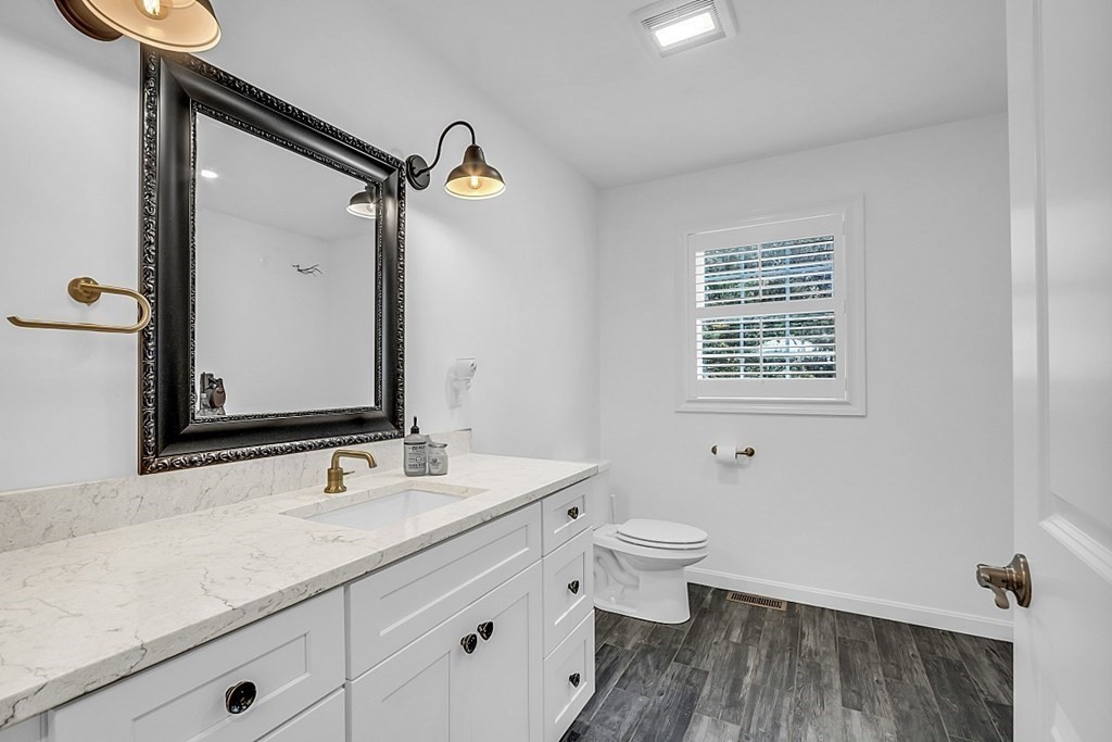 22 Paper Birch Path, Unit 36 Worcester, MA 01605 - Photo 17 of 34 a bathroom with a double vanity sink a toilet and a mirror