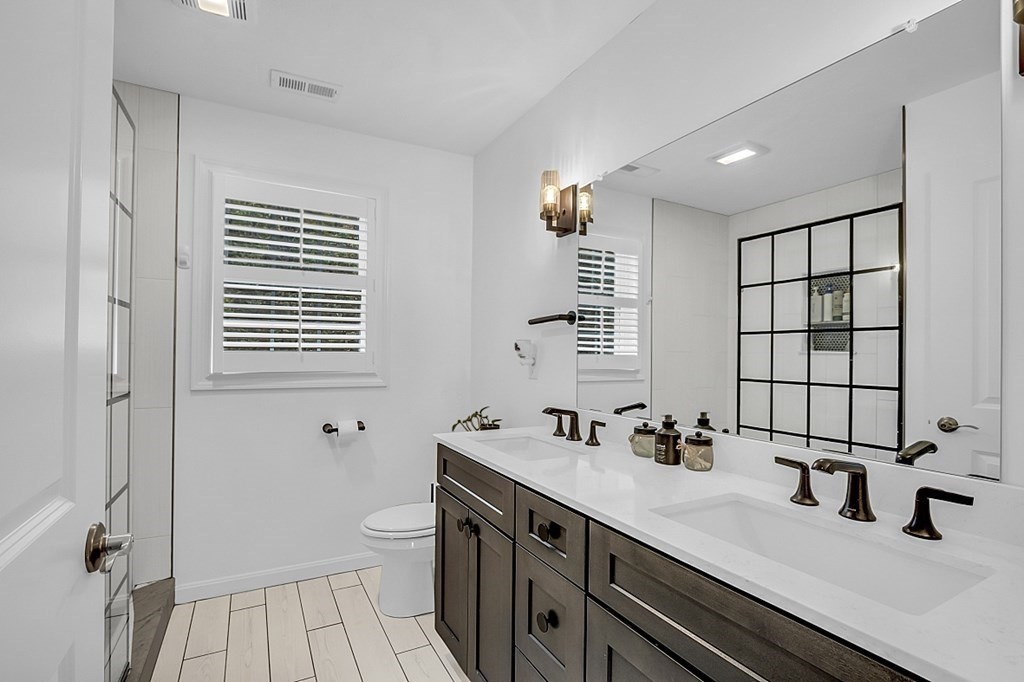 22 Paper Birch Path, Unit 36 Worcester, MA 01605 - Photo 22 of 34 a bathroom with a double vanity sink a toilet and a mirror