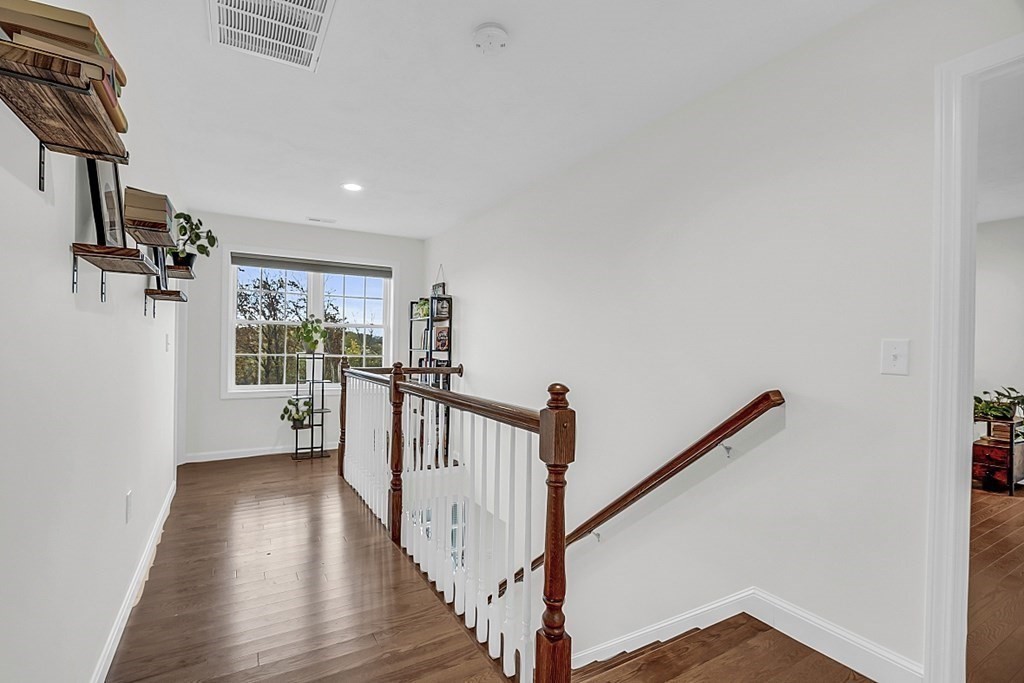 22 Paper Birch Path, Unit 36 Worcester, MA 01605 - Photo 27 of 34 a view of a hallway with wooden floor and staircase