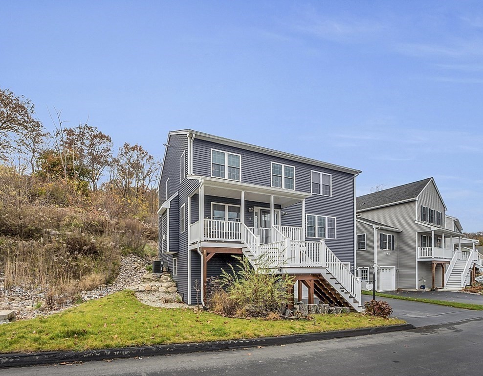 22 Paper Birch Path, Unit 36 Worcester, MA 01605 - Photo 29 of 34 a front view of a house with a yard