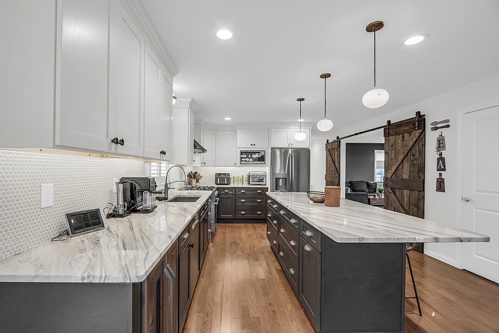 22 Paper Birch Path, Unit 36 Worcester, MA 01605 - Photo 7 of 34 a kitchen with granite countertop a sink a counter top space appliances and cabinets