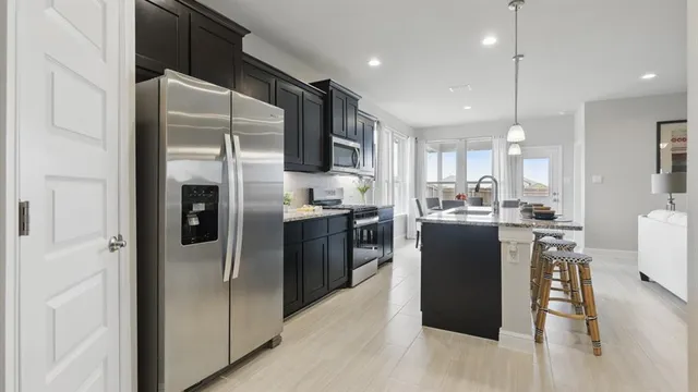 a kitchen with sink a microwave a stove and refrigerator