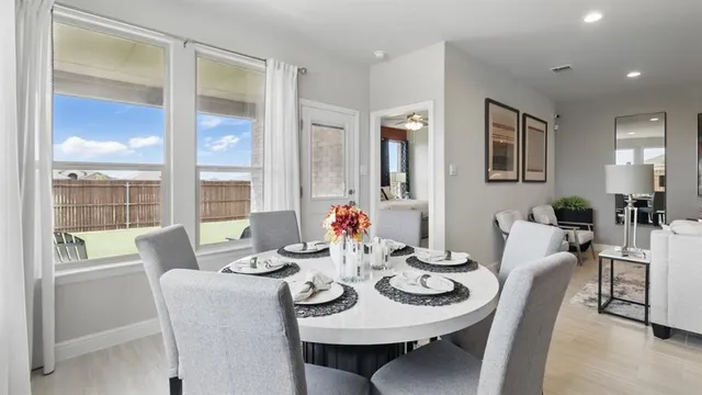 a kitchen with a stove a table and chairs in it