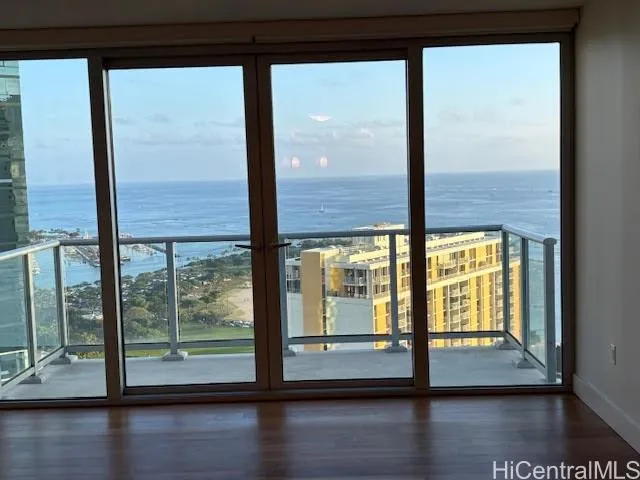 a view of empty room with wooden floor and floor