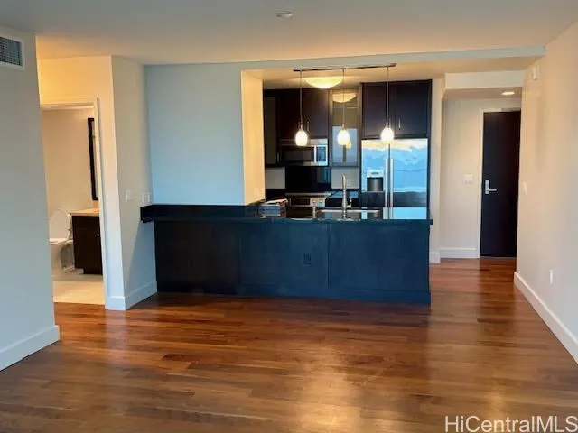 a view of kitchen with cabinets and wooden floor