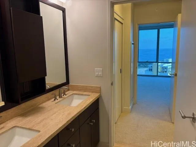 a bathroom with a granite countertop sink and a mirror
